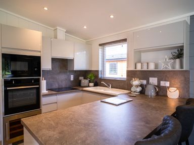 A kitchen with modern appliances and a sink at Royal View in Waltham