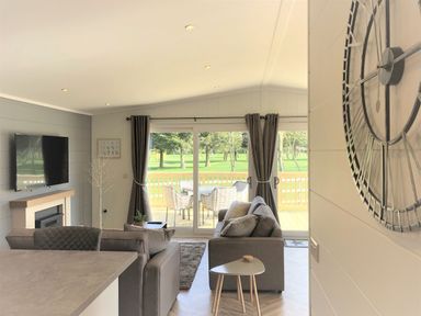 A living room with a sofa and television at Royal View in Waltham