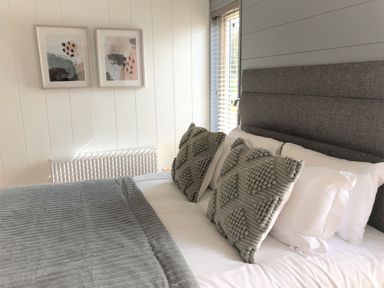 A bedroom with a bed and wall art at Royal View in Waltham