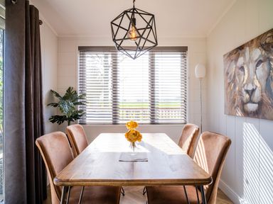 A dining room with a table and chairs at Goldfinch in Waltham