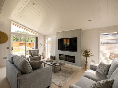 A living room with a sofa and armchair at The Luxury Hideaway in Waltham