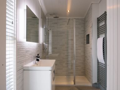 A bathroom with a shower and washbasin at The Luxury Hideaway in Waltham