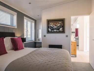 A bedroom with a bed and wall art at The Luxury Hideaway in Waltham