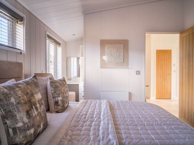 A bedroom with a bed and dresser at Luxurious Serenity in Waltham