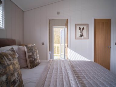 A bedroom with a bed and doors leading outside at Luxurious Serenity in Waltham
