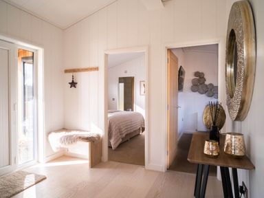 A hallway with a bench and decorative elements at Luxurious Serenity in Waltham
