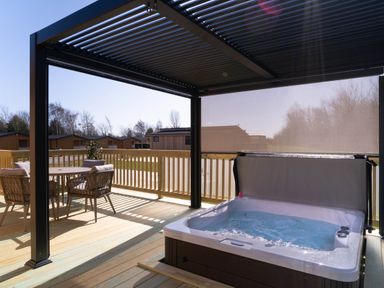 An outdoor area with a hot tub and patio furniture at The Luxury Escape in Waltham