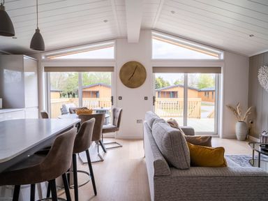 A living room with a sofa and dining area at The Luxury Escape in Waltham