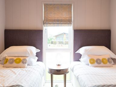 A bedroom with two beds and a window at The Henley in Waltham