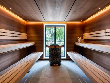 A sauna with wooden benches and a window at The Henley in Waltham