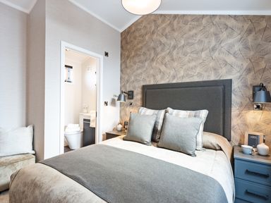 A bedroom with a bed and door to a bathroom at Shangri-La in Waltham