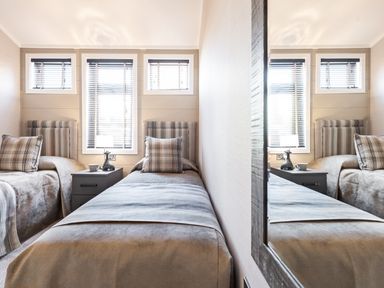A bedroom with two single beds and a bedside table at Shangri-La in Waltham