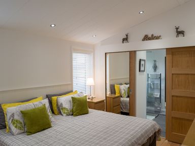 A bedroom with a bed and mirror at The Royal in Waltham