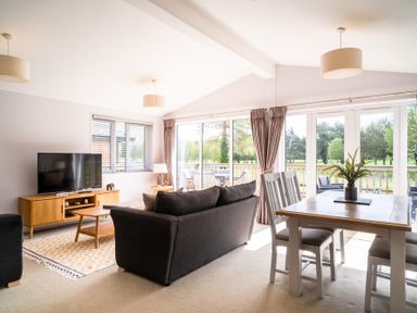 A living room with a sofa and television at The View in Waltham