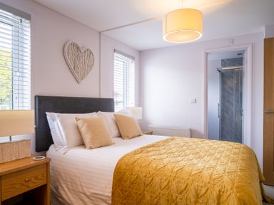 A bedroom with a bed and lamp at The View in Waltham