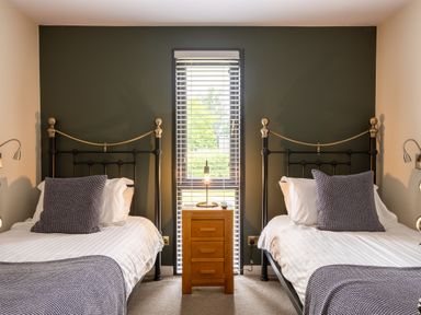 A bedroom with two beds and a nightstand at Macosi in Waltham