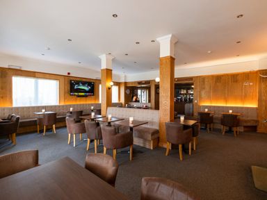 A dining room with tables and chairs at Macosi in Waltham