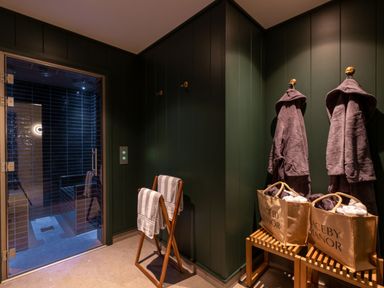 A sauna entrance with towels and bathrobes at Macosi in Waltham