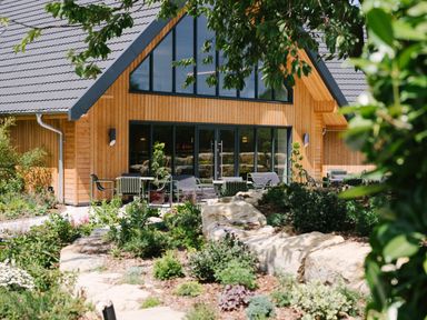 An outdoor seating area with chairs and tables at The Luxury Retreat in Waltham