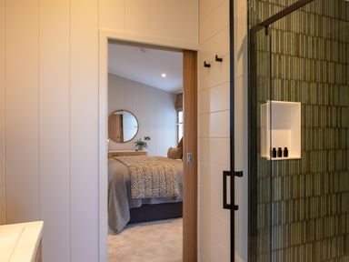 A bedroom with a bed and mirror at Exclusive Aura Spa in Waltham