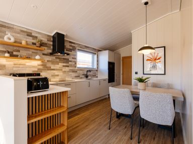 A kitchen with dining table and chairs at Luxury Boutique Retreat Pet in Waltham