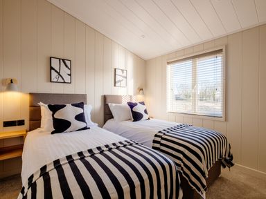 A bedroom with two beds and a window at Luxury Boutique Retreat Pet Waltham