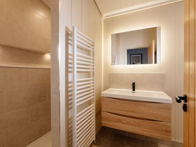 A bathroom with a sink and towel radiator at Luxury Boutique Retreat Pet in Waltham