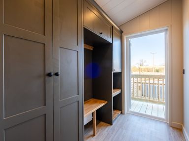A storage room with a cabinet and a door at Luxury Boutique Retreat Pet in Waltham