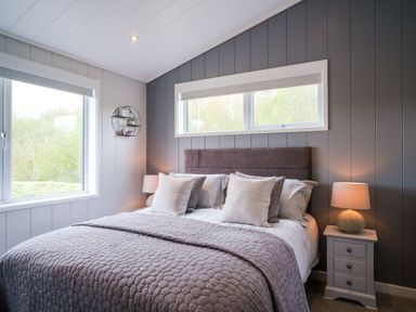 A bedroom with a bed and windows at Marrakech in Waltham
