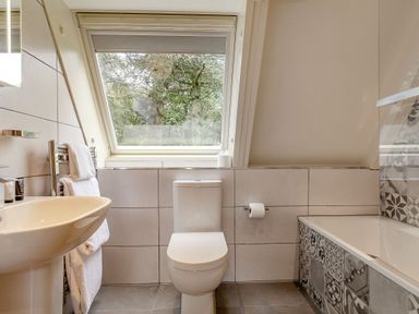 A bathroom with a toilet and sink at St Ives Studio Spa in Praze-An-Beeble