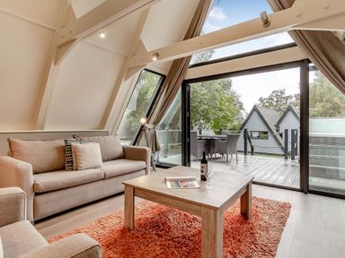A living room with a couch and coffee table at St Ives Studio Spa in Praze-An-Beeble