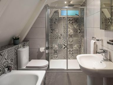 A bathroom with a shower, bathtub, toilet, and sink at St Ives Lodge 2 Spa in Praze-An-Beeble