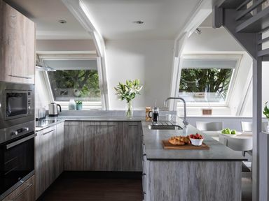 A kitchen with cabinets and a table with food at St Ives Lodge 2 Spa Praze-An-Beeble