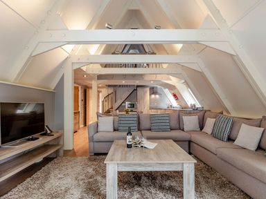 A living room with a sofa and TV at St Ives Lodge 3 Spa in Praze-An-Beeble