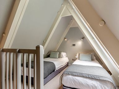 A bedroom with two beds and a decorative pillow at St Ives Lodge 3 Spa Praze-An-Beeble