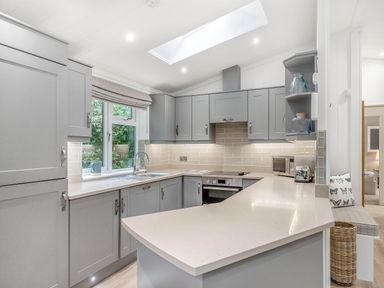 A kitchen with cabinets and a countertop at Aubyn Lodge Spa in Praze-An-Beeble