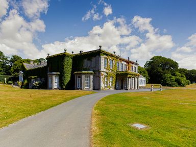 A building with garden and driveway at Aubyn Lodge Spa in Praze-An-Beeble