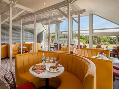 A dining room with booths and tables at Aubyn Lodge Spa in Praze-An-Beeble