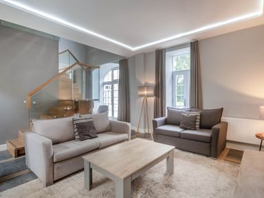 A living room with two sofas and a coffee table at Coach House in Praze-An-Beeble