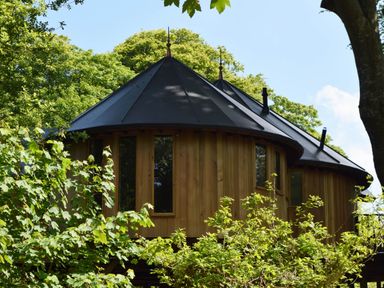 A tree house surrounded by greenery at The Treehouse in Praze-An-Beeble
