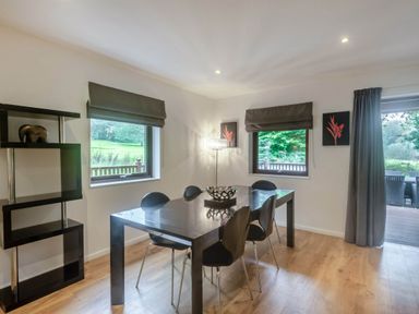 A dining room with a table and chairs at Cornwall Lodge Spa in Praze-An-Beeble