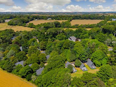 A view of houses and trees in a natural setting at St Austell Lodge Spa in Praze-An-Beeble