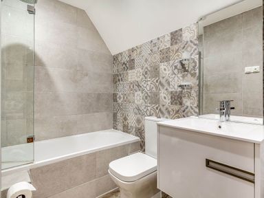 A bathroom with a bathtub and sink at The Gatehouse in Praze-An-Beeble