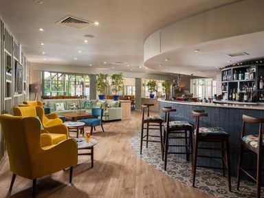 A lounge with seating and a bar at Woodland Lodge Spa in Praze-An-Beeble