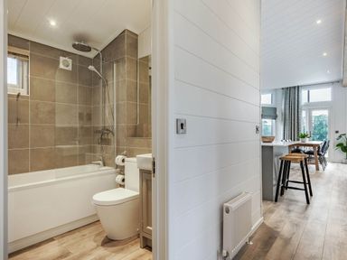 A bathroom with a bathtub and toilet at Lake View Spa, Praze-An-Beeble