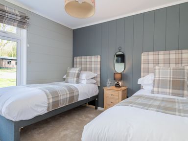 A bedroom with two beds and bedside table at Argel Spa, Praze-An-Beeble