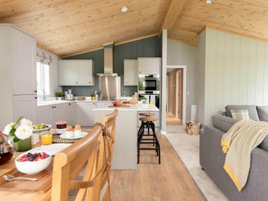 A kitchen with a dining area and a sofa at Argel in Praze-An-Beeble