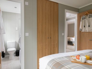 A bedroom with a bed and attached bathroom at Argel in Praze-An-Beeble