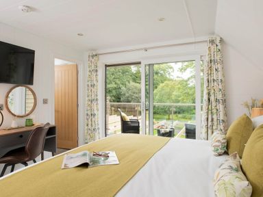 A bedroom with a bed and desk at Kilden Pet in Praze-An-Beeble