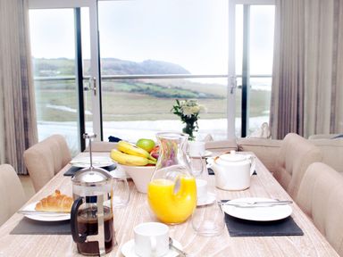 A dining table with breakfast items at Milk Wood 2 Spa Laugharne